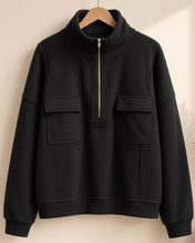 Load image into Gallery viewer, Black half-zip pullover on hanger